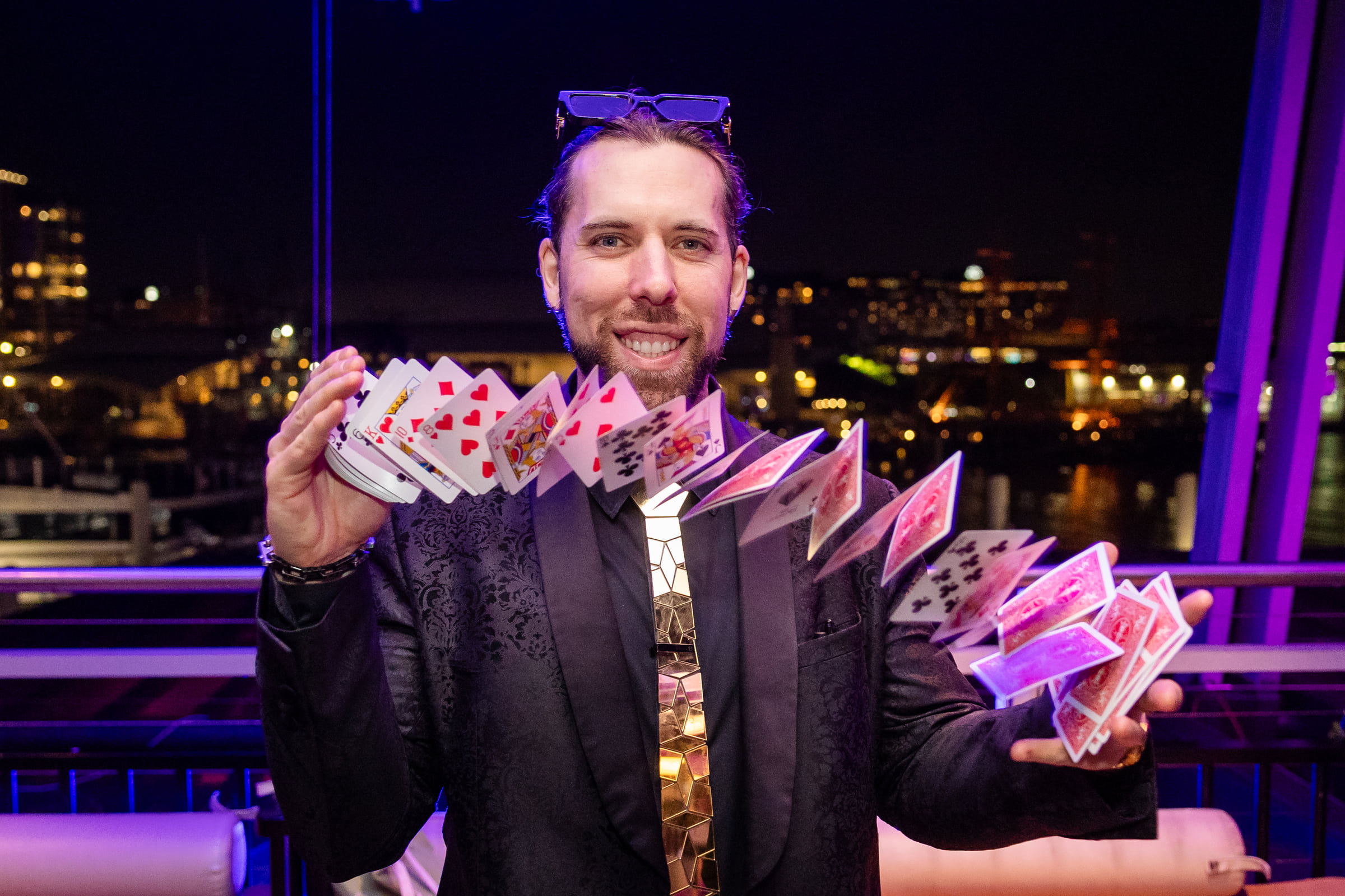 A magician performing with playing cards at Nick Bendel's book launch