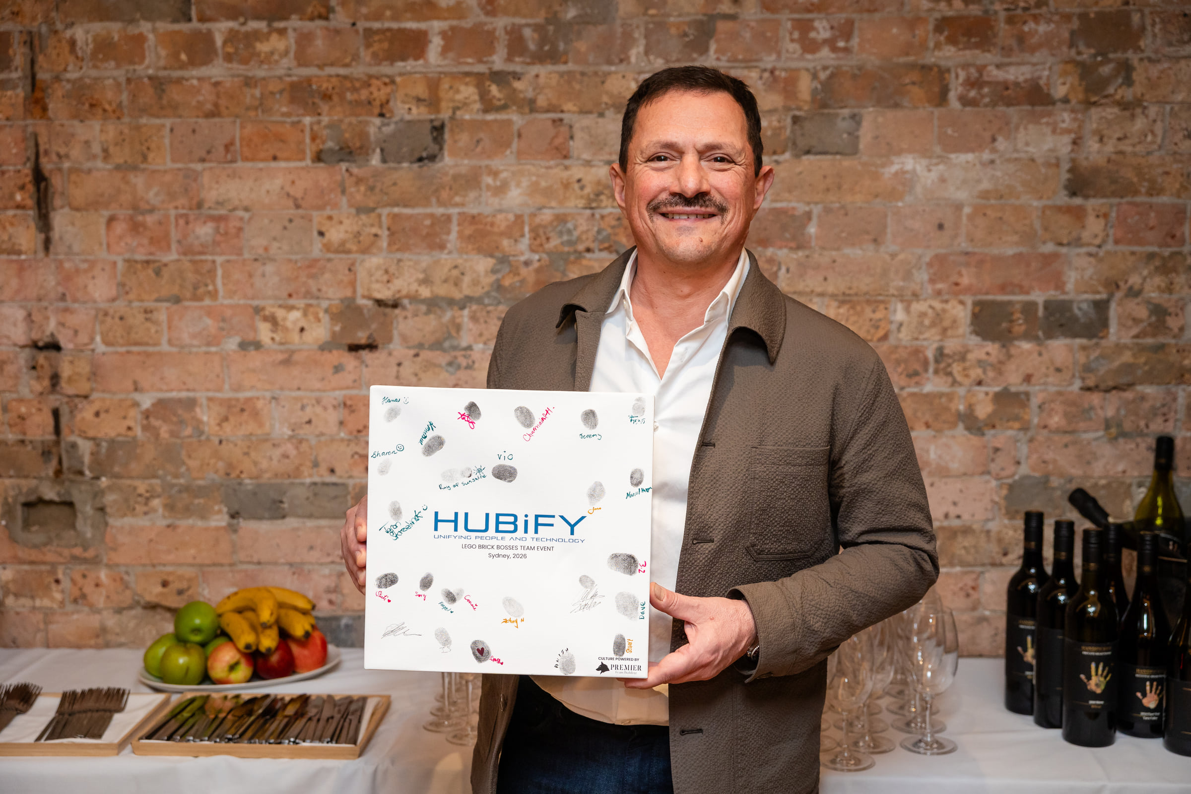 Hubify leader holding the signed Brick Bosses team keepsake
